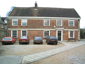 The house is a two-storeyed red brick building of about 1665 with a Dutch gable on the west front. The east side is earlier, of stone with a 15th or 16th century window on the first floor.