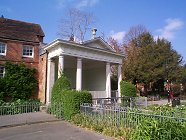 18th Century Garden Temple. Abbey House. Built across conduit to Mill circa 1750. Possibly designed by William Pescod in 1751, and only a fragment of the original. Roman-Doric portico of four columns, entablature and pediment crowned by urns.   18th Century Abbey Mill. Red brick with tiled roof. 2-storey, gabled water mill. Irregular sash and casement windows.